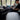 Man using his phone on the sofa while wearing Sommet PB5000 compression recovery boots